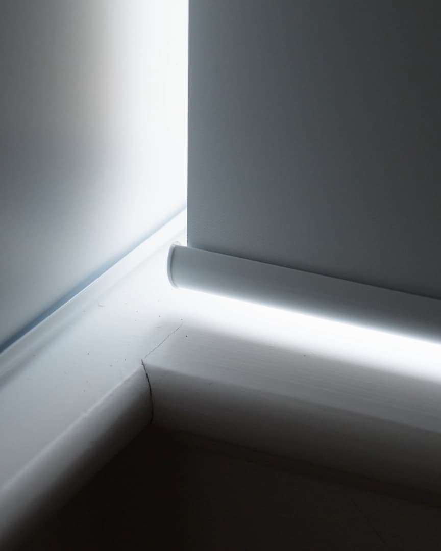 Daylight leaking in a bright strip around the bottom rail and edges of a standard roller blind.
