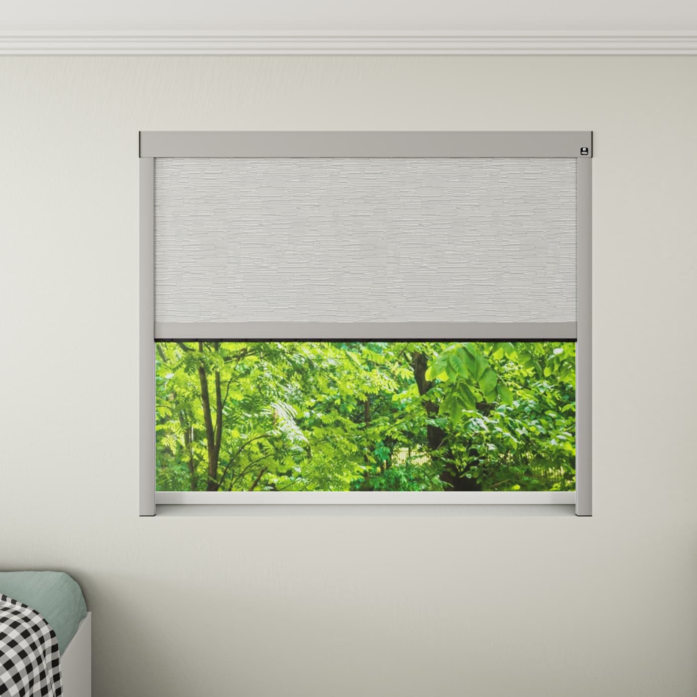 Motorised blackout blind half raised over a bedroom window.