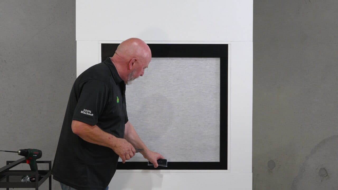 Photo: pushing the crossbar down to close a light gap.
