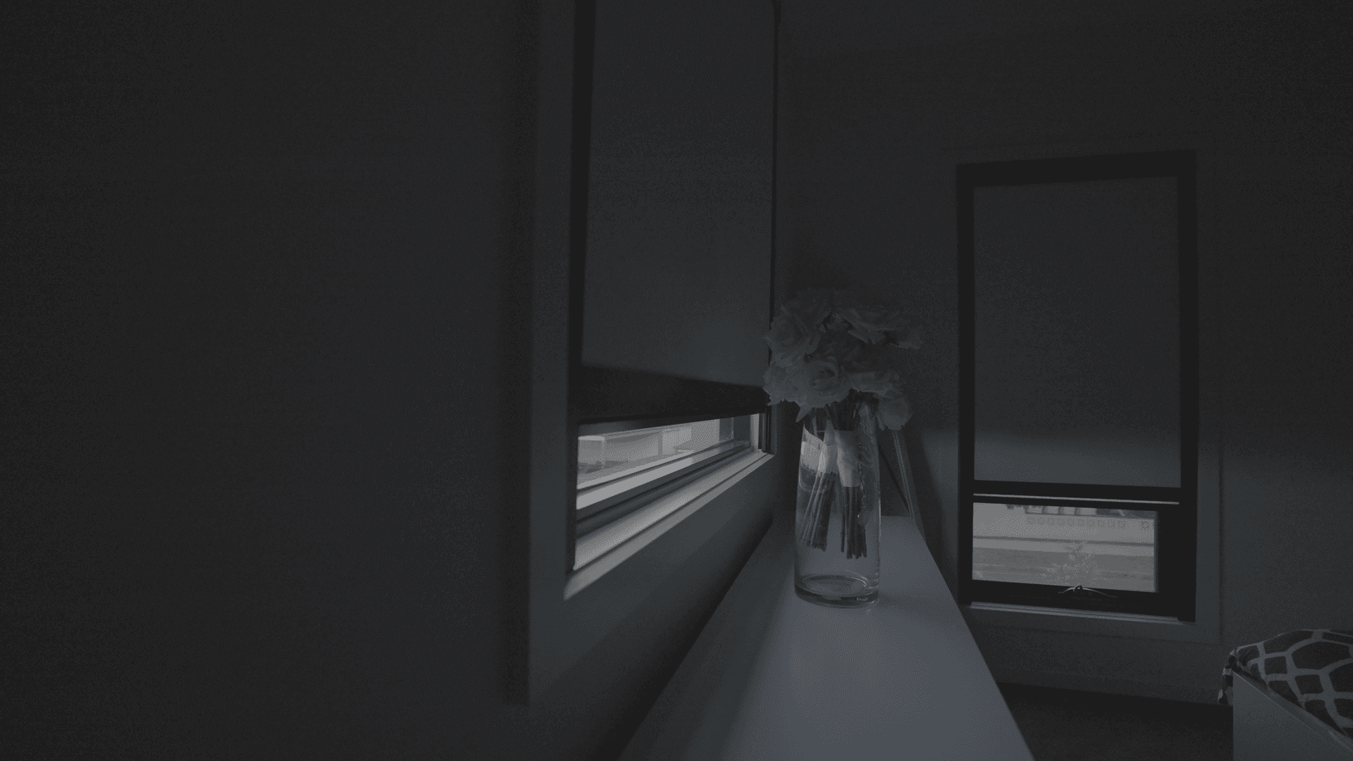 Dim bedroom with the blackout blind down.