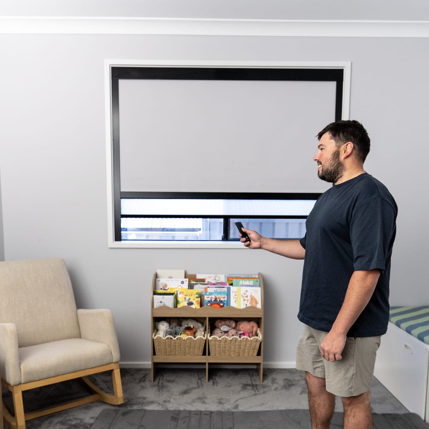 Dual blind on a nursery window operated by remote, blackout most of the way down with the sheer below.