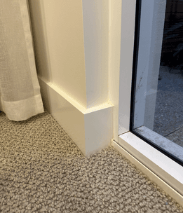 Skirting board running below a sliding door reveal.