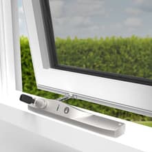 Window winder handle attached to the side of a window frame.
